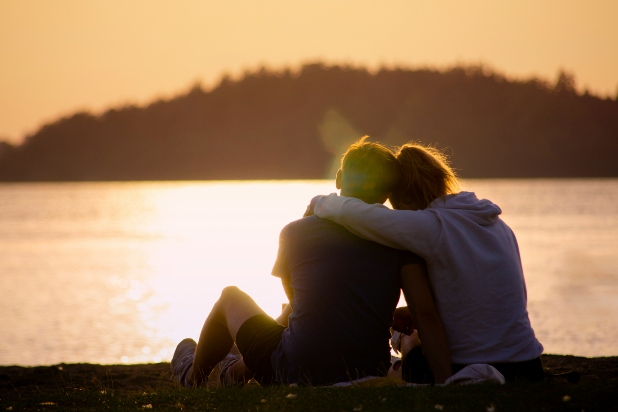 A woman with her arm around a man