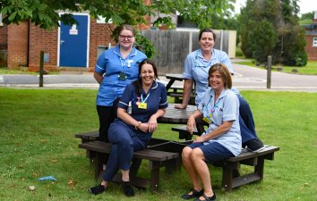 Group of staff sitting on picnic benches